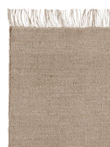 Armadillo Willow Rug in Kiln, corner close-up of the linen, wool, and jute pile and edge