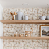 Sir Madam set of hand-carved beechwood spoons in a glass jar on a kitchen shelf with decorative floral tiles