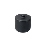 Bitters Co matte black barro clay sugar bowl with a minimalist cylindrical design and matching lid.