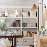 Calimia Home pillow wall with the Long Hood Chandelier, Basket Swing-Arm Wall Sconce and Marlowe pine buffet