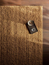 Armadillo Mason Rug in Yolk, overhead view of the handwoven new zealand wool weave and edge finish