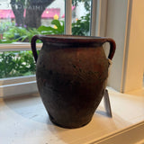 Black and red vintage crock — side view showing glaze detail