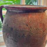 Black and red vintage crock — top view