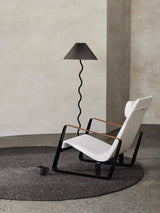 Armadillo Braid Rug in Charcoal, hand-braided wool blend rug shown in a room setting