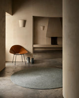 Armadillo Braid Rug in Heron, hand-braided wool blend rug shown in a room setting