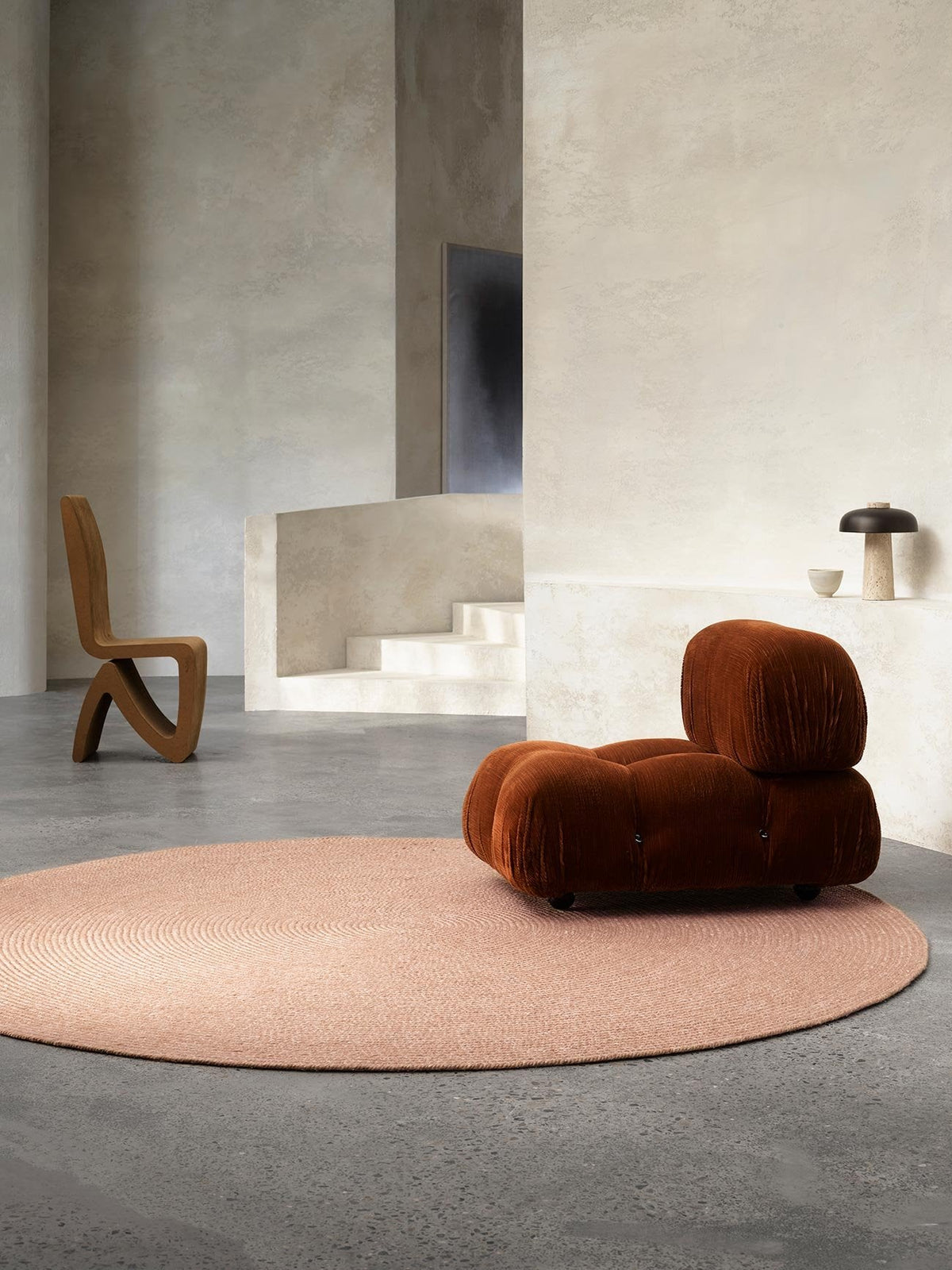 Armadillo Braid Rug in Blush, hand-braided wool blend rug shown in a room setting