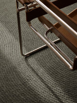Armadillo Braid Rug in Ivy, a second view of the hand-braided wool blend rug in a styled interior