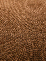 Armadillo Braid Rug in Persimmon, overhead view of the hand-braided wool blend weave and edge finish