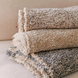 Calimia Home Brentwood throw in pebble featuring a soft multi-tonal bouclé texture and hand-loomed fringe detail.