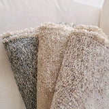 Calimia Home Brentwood pebble throw blankets featuring hand-loomed multi-tonal bouclé texture and frayed edges