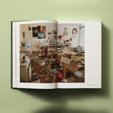 Calimia Home Bruce Weber My Education book open to a spread showing a photograph of a crowded studio archive room.