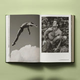 Calimia Home Bruce Weber My Education book open to a spread showing a diver in mid-air above the clouds and a portrait.