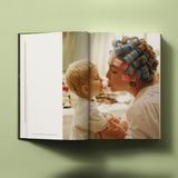 Calimia Home Bruce Weber My Education book open to a spread showing a colour portrait of a woman in hair rollers with a small child.