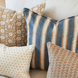 Walter G Buzios Desert pillow with blue and tan stripes, pipe edge, and premium feather insert on a sofa.