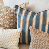 Walter G Buzios Desert pillow with blue and tan stripes, pipe edge, and premium feather insert on a sofa.