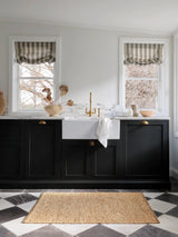 River Nook Rug by Armadillo, handwoven jute rug, styled in a room at Calimia Home