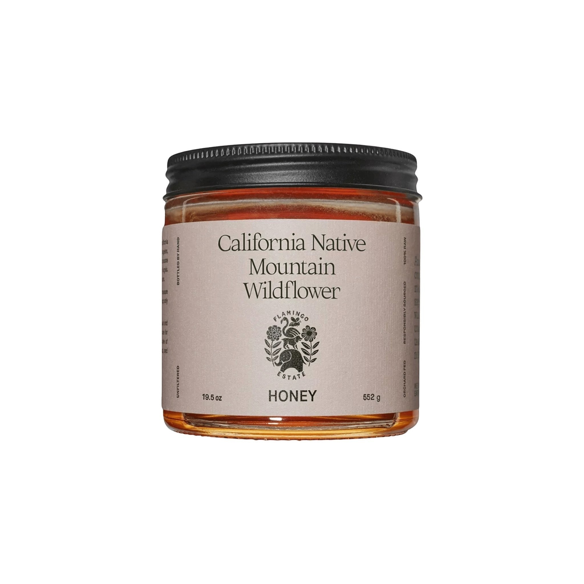 A clear glass jar of Flamingo Estate California Native Mountain Wildflower Honey with a cream label, on a white background.