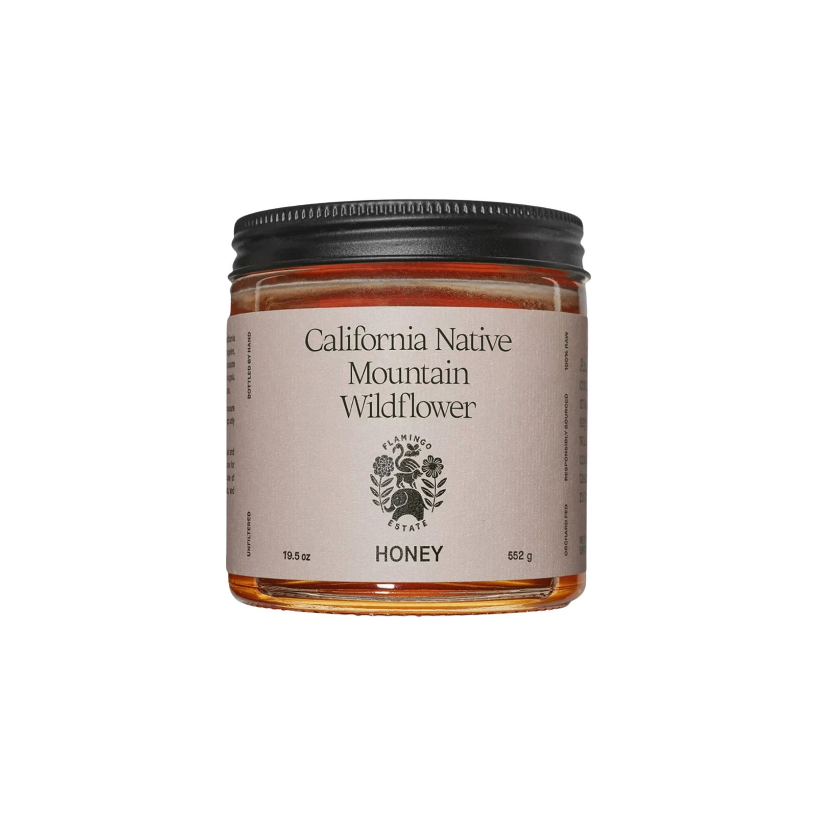 A clear glass jar of Flamingo Estate California Native Mountain Wildflower Honey with a cream label, on a white background.