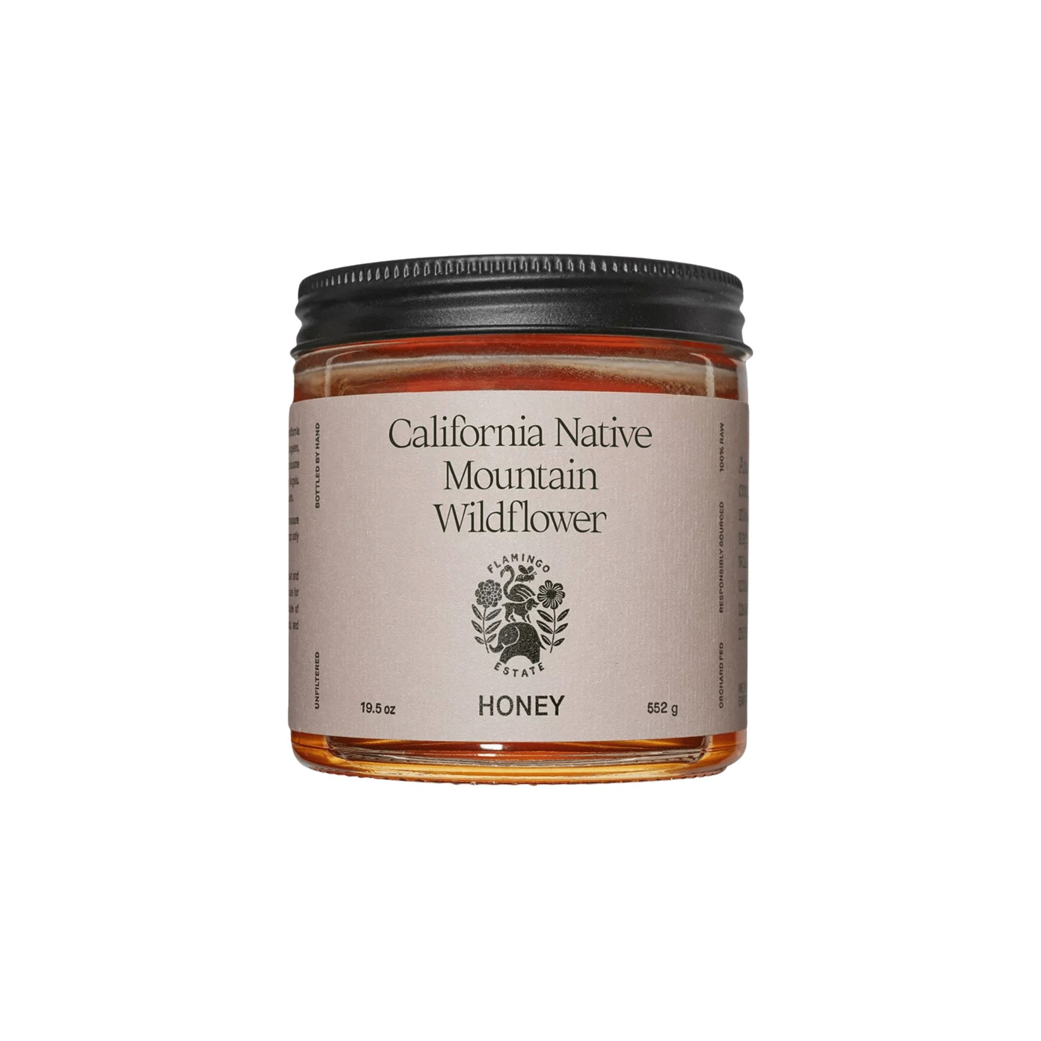 A clear glass jar of Flamingo Estate California Native Mountain Wildflower Honey with a cream label, on a white background.