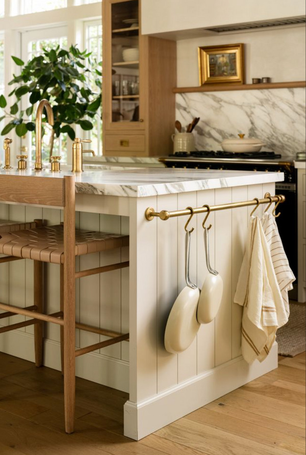 Cream custom kitchen island with marble countertop and brass towel rail by Calimia Home