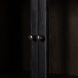 Calimia Home ebony oak cabinet featuring brushed black wood frame, glass doors, and dark iron hardware knobs.