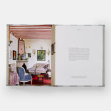 Calimia Home Everybody Loves Stripes book open to a spread showing a sitting room under a red and white striped tented ceiling.