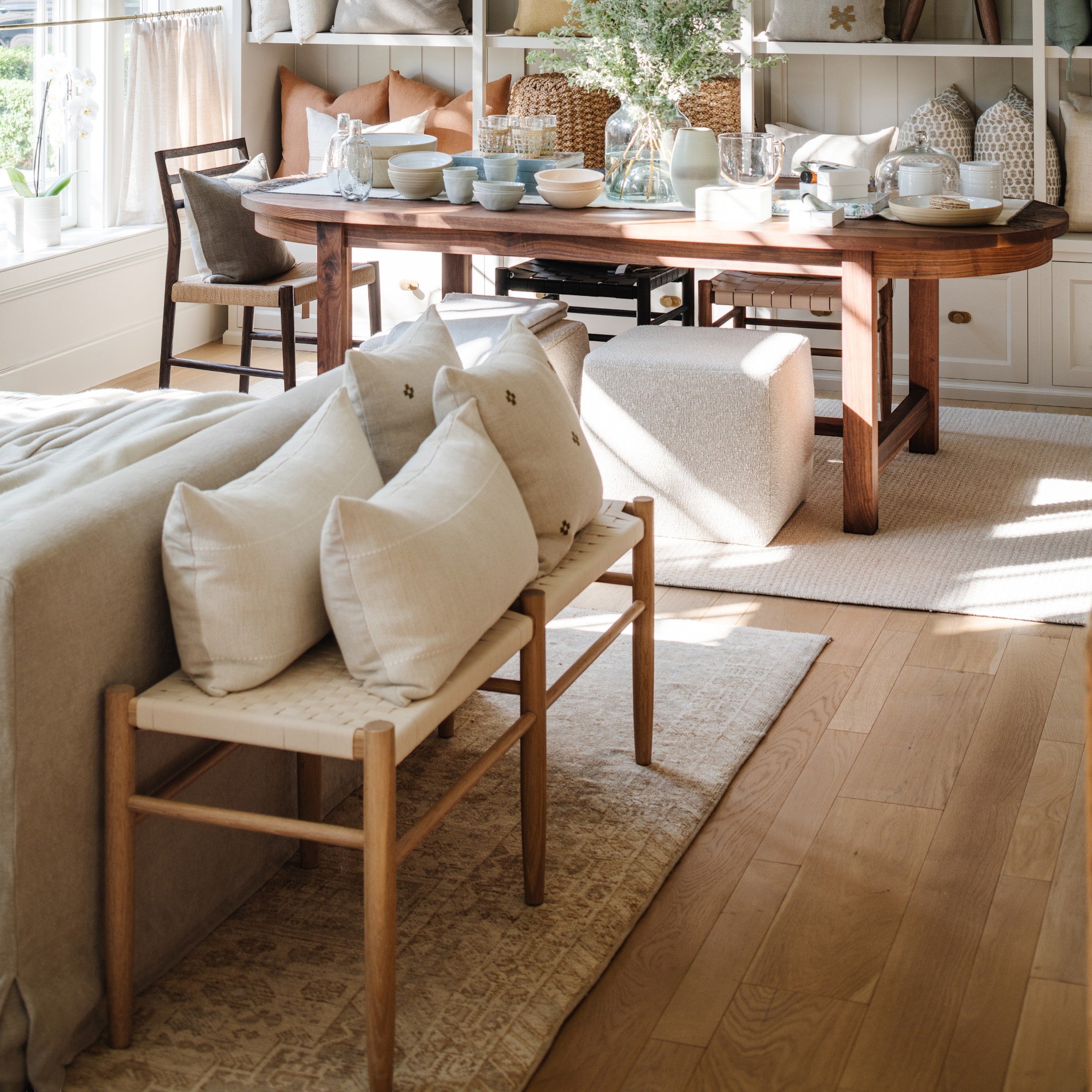 Calimia Home Gaon Bench with white oak frame and woven white canvas seat placed in a bright, elegant living room.