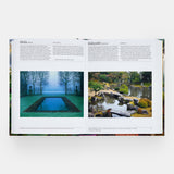 Calimia Home The Garden Book Mini Format book open to a spread showing garden entries with a misty reflecting pool.