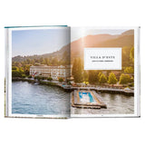 Calimia Home Great Escapes Italy book showing a scenic aerial view of Villa d'Este on Lake Como with a floating pool.