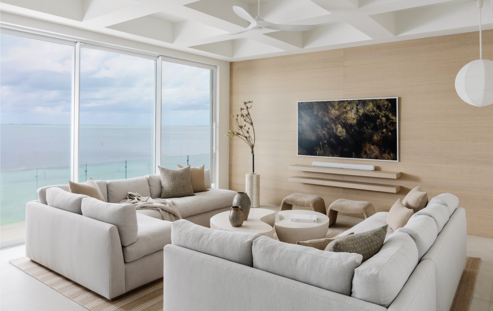 Serene coastal living room with plush white sectionals and ocean views in the Peaceful Waters home, Islamorada