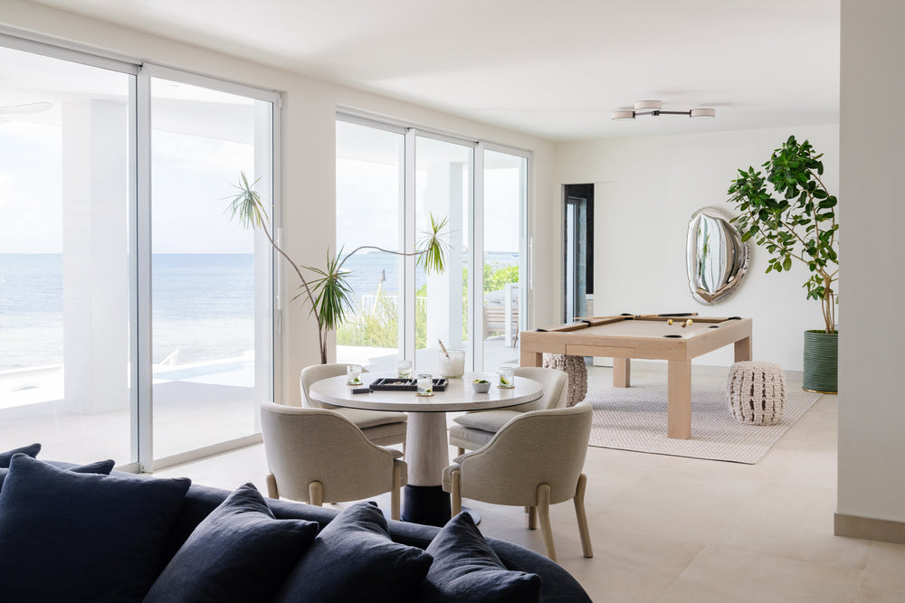 Bright game room with billiards table, round card table, and sweeping ocean views in Islamorada