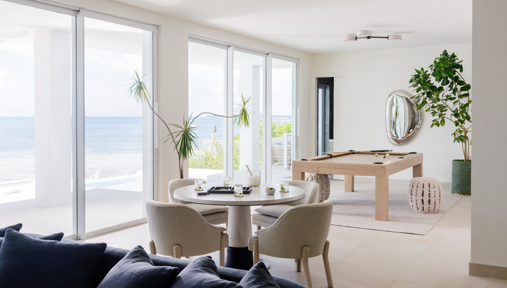 Bright game room with billiards table, round card table, and sweeping ocean views in Islamorada