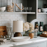 Calimia Home Roli Poli stemless glasses made from clear hand-blown recycled glass on a kitchen counter.