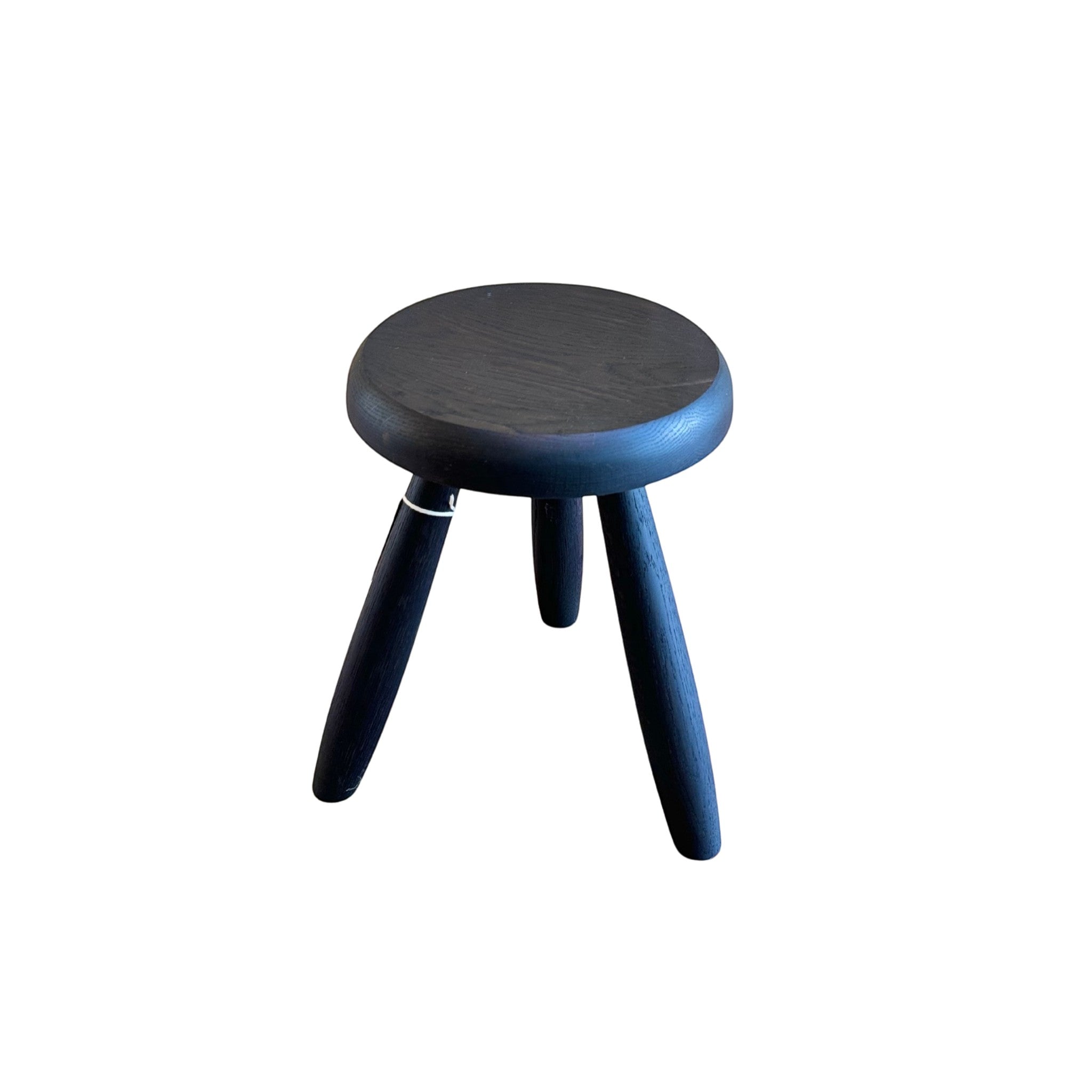 Calimia Home Tori stool in black wood with three tapered legs and a round seat finished in natural hand-rubbed varnish.