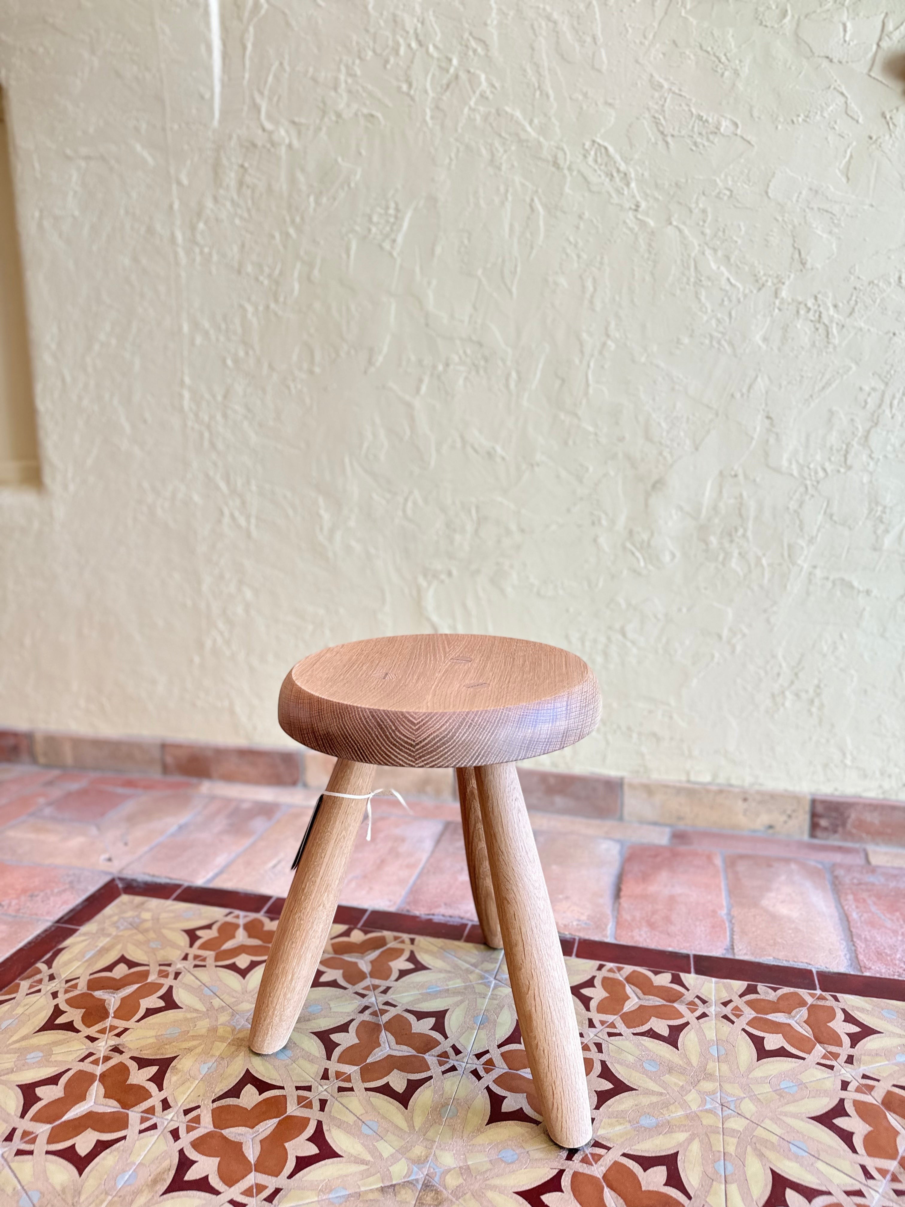 Calimia Home Tori Stool with three tapered wooden legs and a round seat, finished in a natural hand-rubbed varnish.