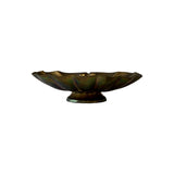 Vintage brass scallop shell dish in profile on its turned pedestal foot, showing iridescent green and rose patina across the lobes