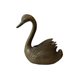 Single vintage brass swan jardiniere facing left, showing cast feather detail across the raised wing and open back