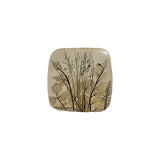 Vintage ceramic botanical wall tile with fine meadow grasses in seed and a fern frond pressed into speckled cream stoneware, the largest of three