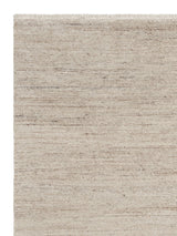 Armadillo Camino Rug in Sawdust, corner close-up of the undyed new zealand and european wool pile and edge