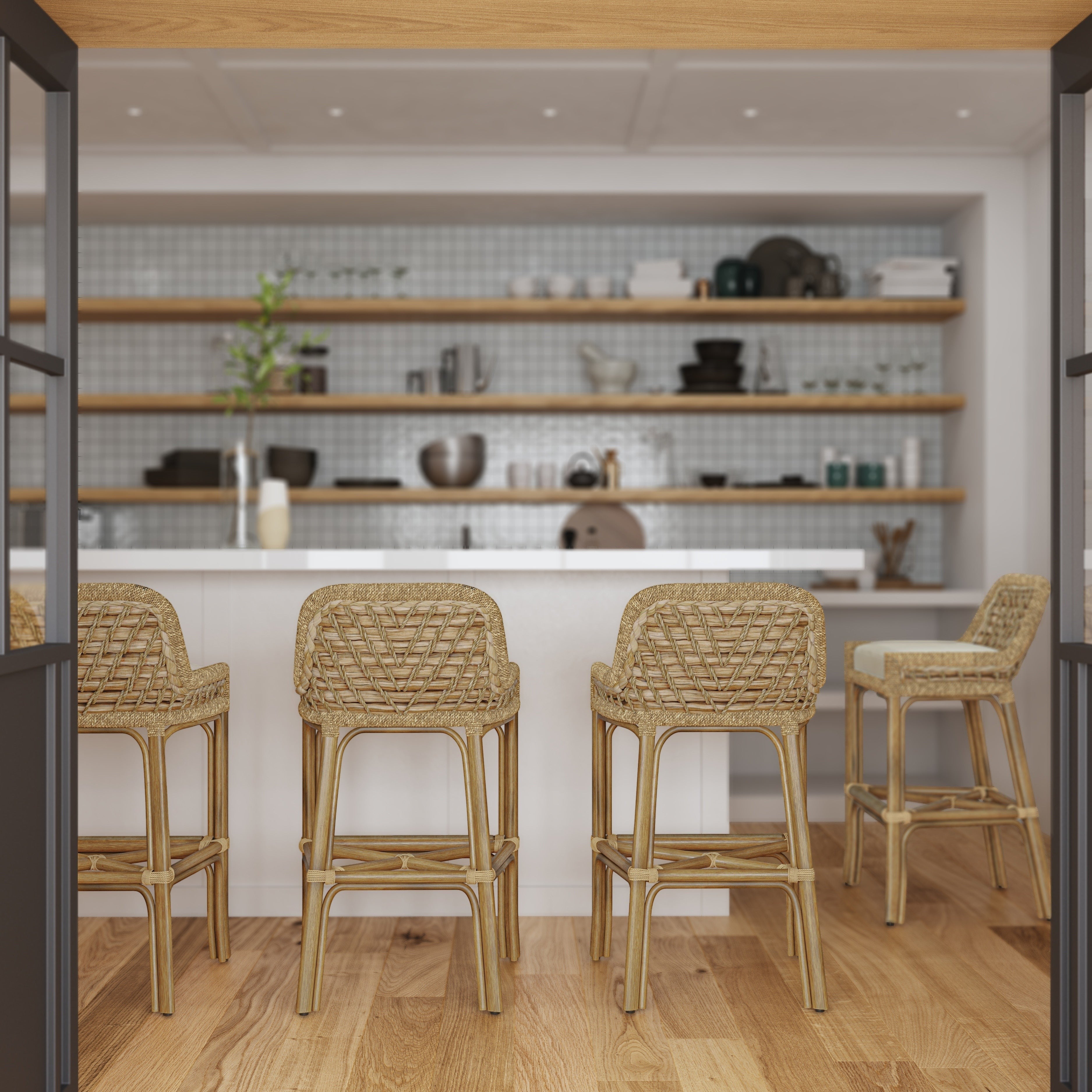 Calimia Home Capitola bar stools with natural pole rattan frames and woven seagrass seats in a bright kitchen setting.