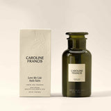 Caroline Francis Love My Life Bath Salts bottle beside its embossed cream box, which lists jasmine, rose, and cedarwood essential oils.