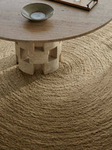 Armadillo Nimbus Rug in Wasabi, hand-braided new zealand wool rug shown in a room setting