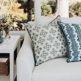 Maison Venu Celeste Lapis pillow with floral embroidery and hidden zipper on a white sofa