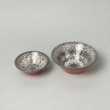 Calimia Home hand-thrown grey floral bowls with intricate patterns and terracotta base, made in Portugal.