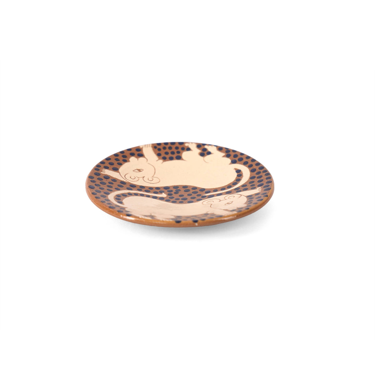 Detail of the hand-painted lion cubs and navy dots on the Kiliim ceramic small plate