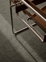 Armadillo Braid Rug in Ivy, a second view of the hand-braided wool blend rug in a styled interior