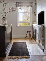 Armadillo Sahara Nook Rug in Charcoal, double-woven jute rug shown in a room setting