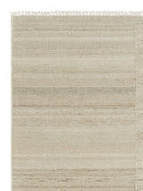 Armadillo Selva Rug in Oat, corner close-up of the afghan wool pile and edge