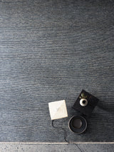 Armadillo Corsica Rug in Indigo, a second view of the handwoven wool and linen rug in a styled interior