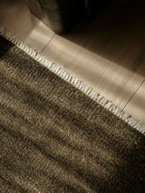 Armadillo Thatch Rug in Gumnut, a second view of the hand-knotted wool rug in a styled interior